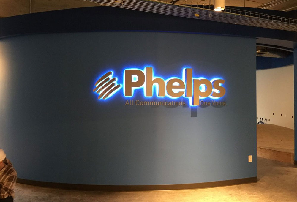 Illuminated Phelps logo at the completed workplace technology project