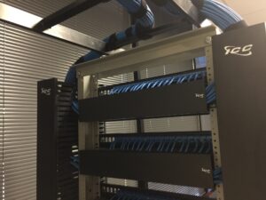 Nicely groomed network cabling in a rack with cable management.